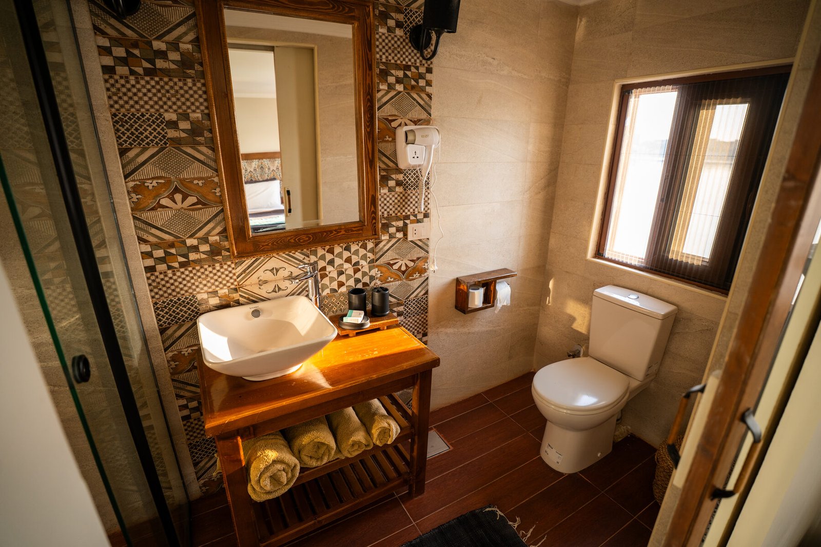 NR-ES dahabiya bathroom with sink, shower area, towels, and warm interior details