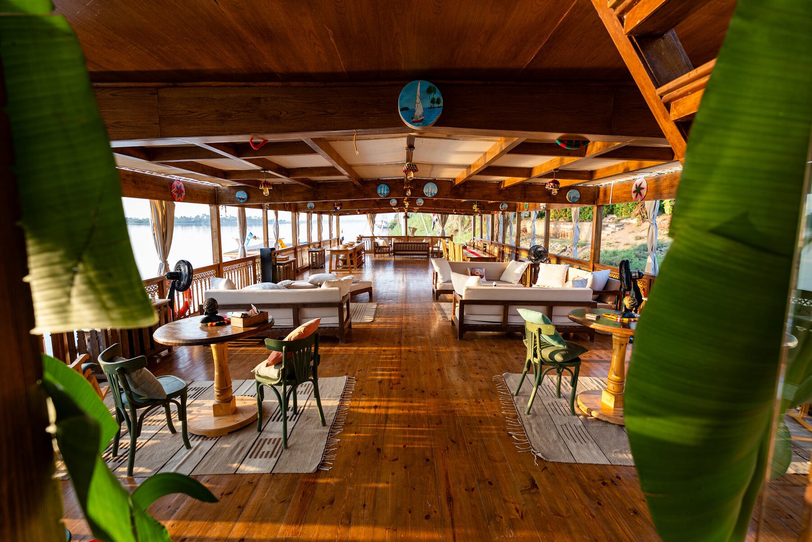 NR-ES dahabiya wooden lounge deck with warm boutique Nile atmosphere