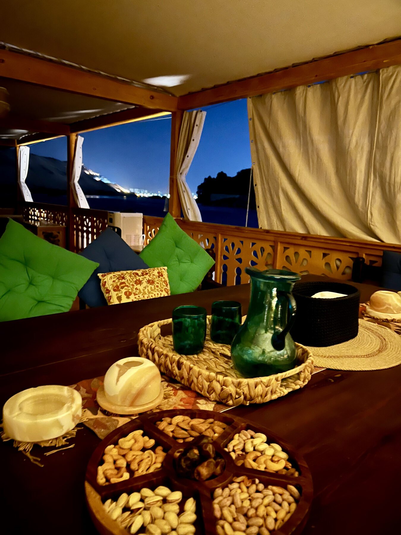 NR-RZ dahabiya evening deck table with snacks and warm Nile atmosphere
